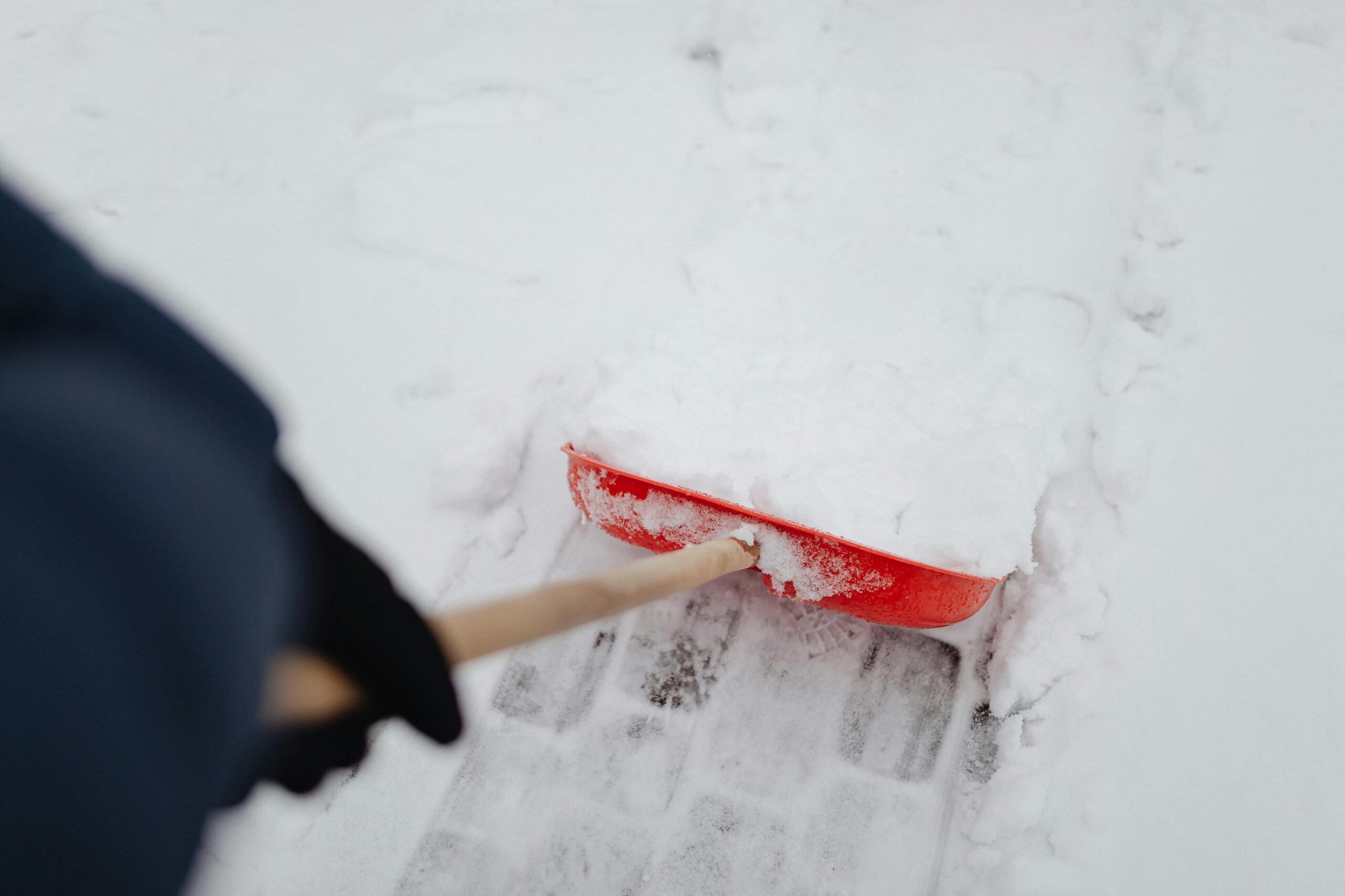 Man is removing snow. A close shot view.